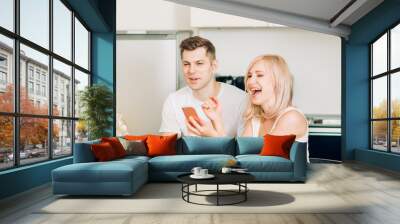 Friends sitting at table in kitchen Wall mural