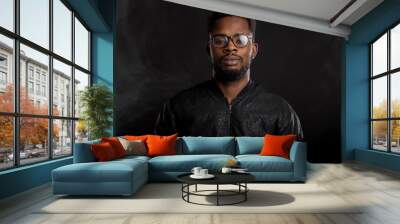 Portrait of handsome young African man on black background Wall mural