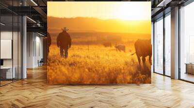 Two men wearing cowboy hats walk through a field of cows Wall mural