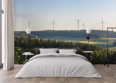 Wind turbines at the horizon in green rural landscape in Werbach, Germany.  Alternative renewable green energy  Wall mural