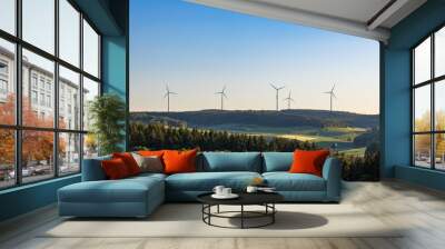 wind turbines in green field against blue sky in summer in Germany. alternative sustainable energy for climate change Wall mural