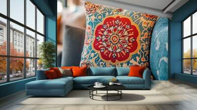 A close-up of a colorful throw pillow with intricate patterns on a sofa. Wall mural