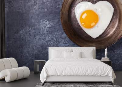 fried egg in heart shape on the pan.holiday valentine's day.breakfast. healthy food.selective focus. Wall mural