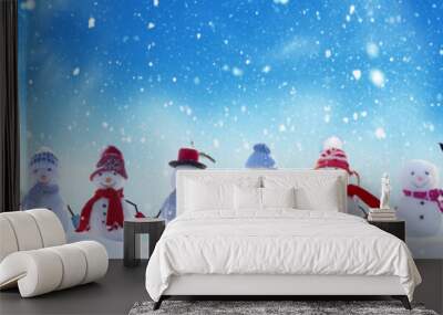 Merry Christmas and happy New Year greeting card with copy-space.Many snowmen standing in winter Christmas landscape.Winter background Wall mural