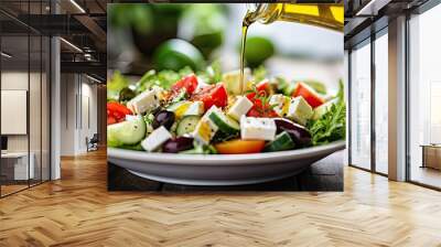 Adding olive oil to a Mediterranean-style vegetable salad accompanied by Greek salad on a white table, featuring wholesome ingredients. Wall mural