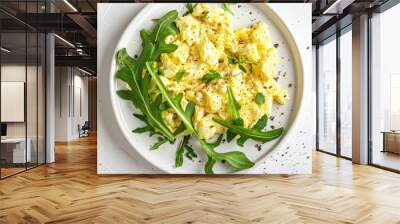 Arugula scrambled eggs on white plate top view Healthy breakfast Wall mural