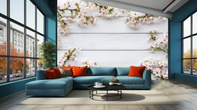 Blooming sakura branch on white wooden background with space for text Wall mural