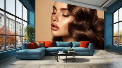 Brunette woman with shiny waves and nude makeup against beige background Wall mural