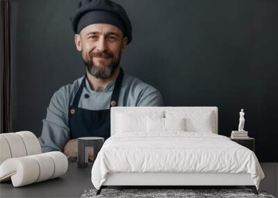 Chef cook with stubble in beret arms crossed looking at camera in a full size body portrait on grey background Wall mural