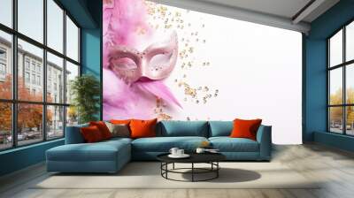 Close-up of white background with pink Venetian carnival mask and confetti, copy space available. Wall mural