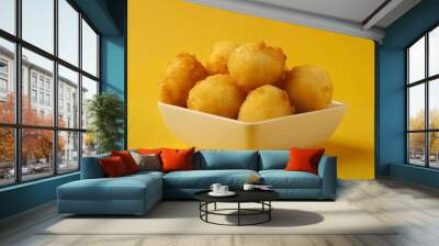 Fried manioc on a yellow background traditional Brazilian food also known as aipim or Macaxeira Wall mural