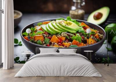 Making a nutritious salad with quinoa avocado sweet potato beans herbs and spinach on a rustic background for a clean healthy vegan vegetarian meal Wall mural