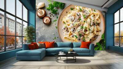 Overhead shot of mushroom pasta with cream sauce and parsley on a stone background Wall mural