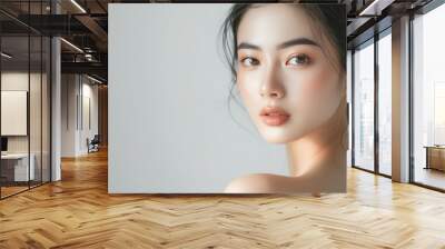 Portrait of a flawless Asian woman with radiant and smooth skin emphasizing facial care treatment and beauty Wall mural