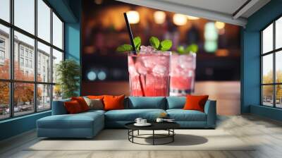 Selective focus on a pink cocktail with ice and mint. Wall mural