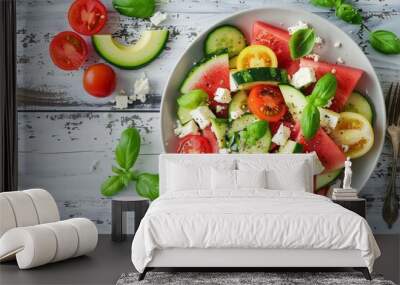 Summer salad with watermelon avocado tomatoes and feta cheese on rustic white wood Wall mural