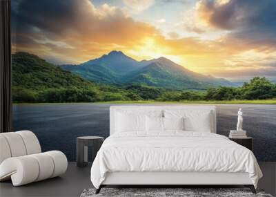 Sunset over asphalt road and green mountain with sky clouds in panoramic view Wall mural