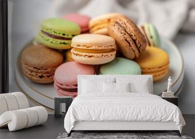 Sweet and colorful French macarons including pastel macarons on a white background with a green beige and brown macaron on a plate Wall mural