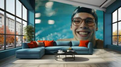 Swimmer wearing cap and glasses happily smiles at pool Wall mural