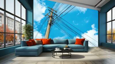 Tangled electric wire on blue sky background Wall mural