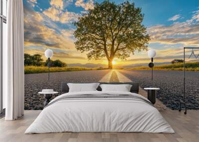 The finish word behind the tree on empty road at sunset with blue sky Wall mural