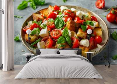 Top view of Panzanella salad with cherry tomatoes mozzarella basil and bread in ceramic plate Wall mural