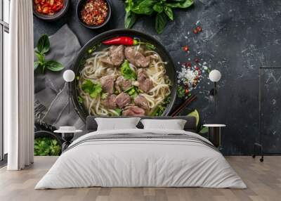 Vietnamese Pho Bo soup with rice noodles beef and herbs on dark background Wall mural