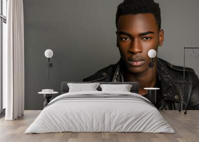 Young African American male model with a casual attire posing naturally on a gray background Wall mural