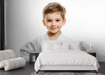 Young Caucasian child on white background doing karate pose with arms on hips and smiling Wall mural