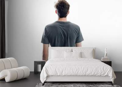 Young man in jeans and t shirt looks away from camera View from behind Collection of people White background Wall mural