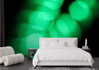 Blurry dreamy view of a blur of green lights. Wall mural