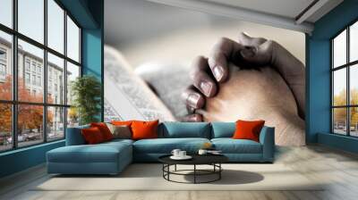 praying hands over a holy bible Wall mural