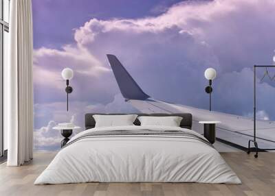 Airplane flying into the clouds Wall mural