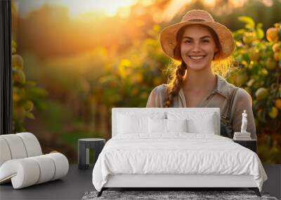 Beautiful young farmer woman holding a wooden box full of quince fruits standing in the orchard with sunset. Concept of healthy lifestyle, local farming and beauty. Wall mural