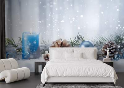 Blue Christmas candles, balls and pine cones in a row with spruce branches covered with snow and snowfall on white wooden board background in winter. Horizontal composition. Wall mural