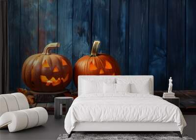 Still life with two shining carved Halloween pumpkins on wooden board surface and background. Concept of Halloween celebration, Trick or Treat and season. Wall mural