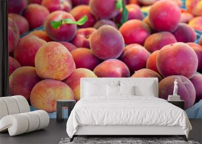 Close-up of fresh yellow summer peaches at an outdoor farmer's market Wall mural