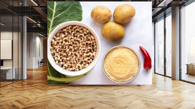 Overhead view of Uncooked blackeye Peas, Collard Greens, cornmeal, potatoes and red pepper in preparation for cooking Wall mural