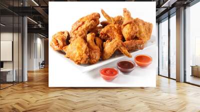 Platter of family sized fried chicken with three sauces on white background with copy space Wall mural