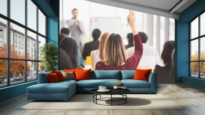 woman raising up hand for asking the speaker and the speaker point the woman in seminar meeting room Wall mural