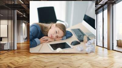 Young beautiful European business woman is sleeping on the table work. Creative woman sleep felling relax after hard work at noon. Co working space concept. Wall mural