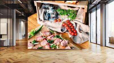 Delicious catering banquet buffet table decorated in rustic style in the garden. Different snacks, sandwiches with ham, chiken, cheese and greenery on a wooden plate. Outdoor. Vertical photo. Wall mural