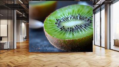 A green kiwi fruit with a spoon next to it Wall mural