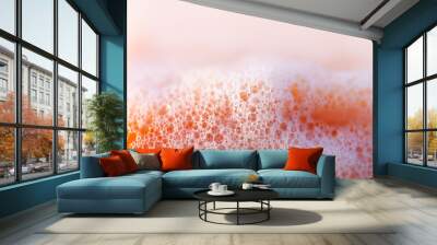 White soap bubbles surrounding an orange object Wall mural