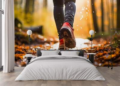 Woman in boots walking through muddy forest puddles in autumn. Hiking boots in the woods closeup. Active lifestyle and outdoor recreation and exercise. Physical activity outside Wall mural