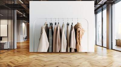 capsule clothes of beige coloron a rack. Closeup Wall mural