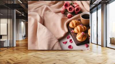 Close up of a cup of coffee, rolls and a bouquet of pink roses on a wooden table. Romantic delicate breakfast or brunch for Valentine's Day, Mother's Day and Women's Day with copy space. Wall mural