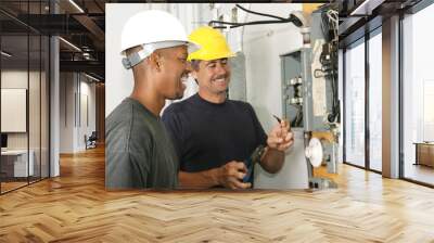 two electricians working on an electrical panel Wall mural