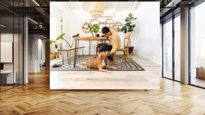 Woman Stroking Dog On Carpet At Home Wall mural