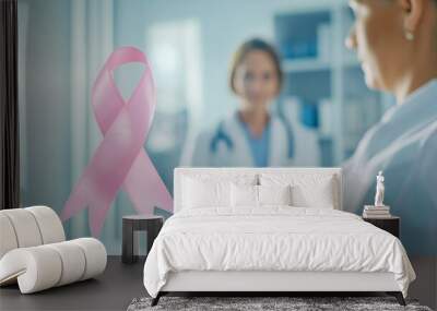 Pink ribbon in foreground with two mammologist doctors in background out of focus for Breast Cancer Awareness Month emphasizing healthcare and support for breast cancer awareness Wall mural